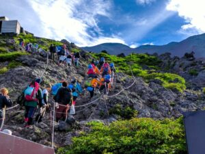 尾根道を歩く登山者と広がる山並みの風景